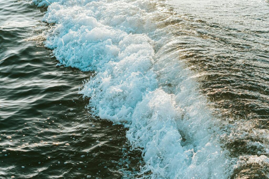 Ocean waves crash against the sandy shore.